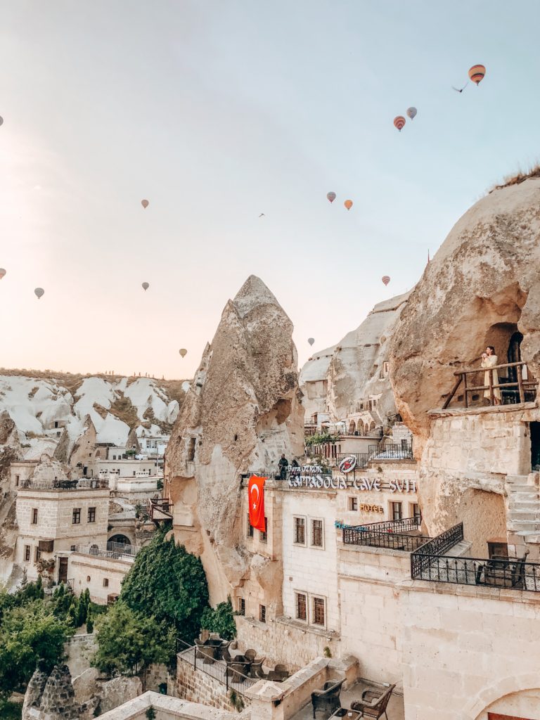 things to do in cappadocia Cappadocia, Turkey rooftop view of hot air balloons. Cappadocia Cave Suites