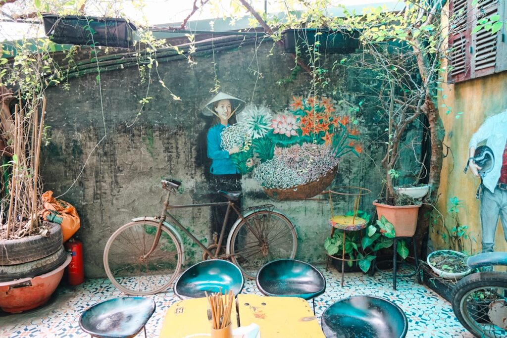 Hidden Gem cafe prettiest cafes showing artwork and seating in Hanoi, Vietnam