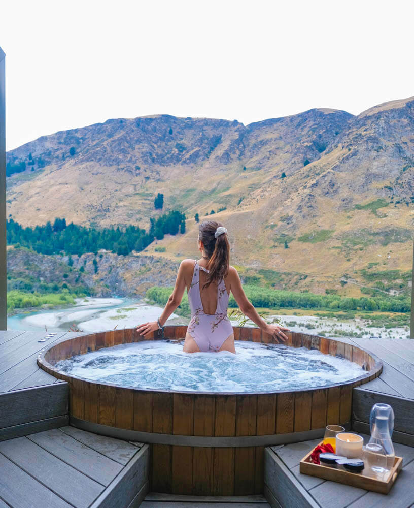 female in a hot tub with views of new zealand 