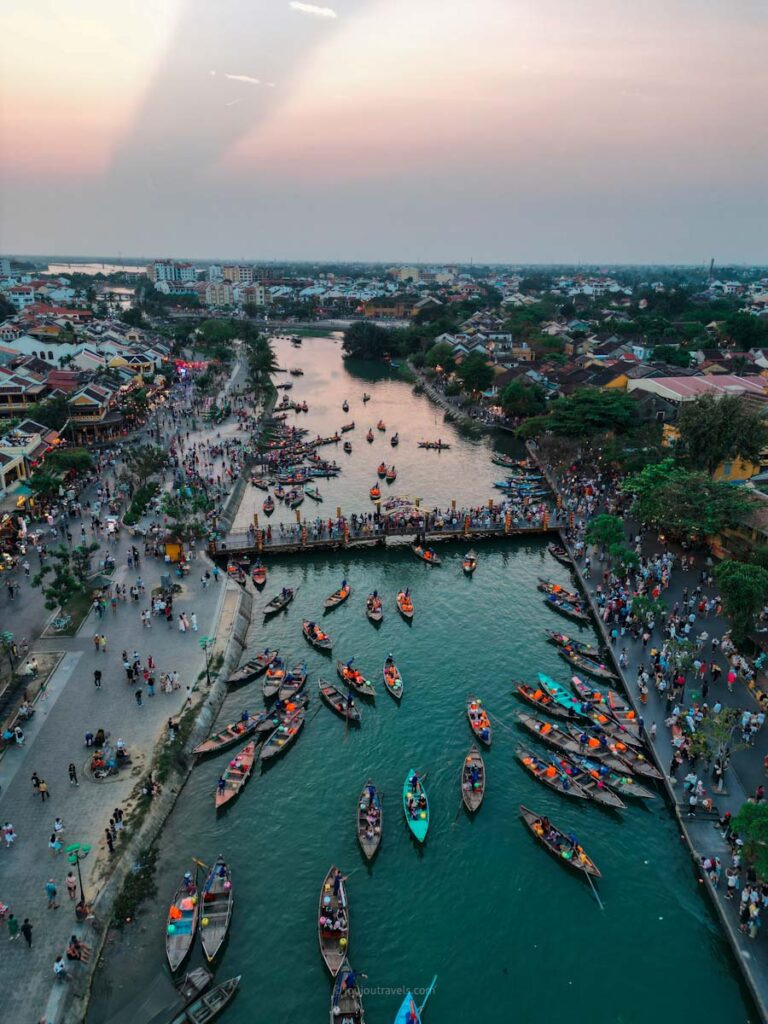 Hoi An drone view of river filled with boats and lanterns for the lantern festival