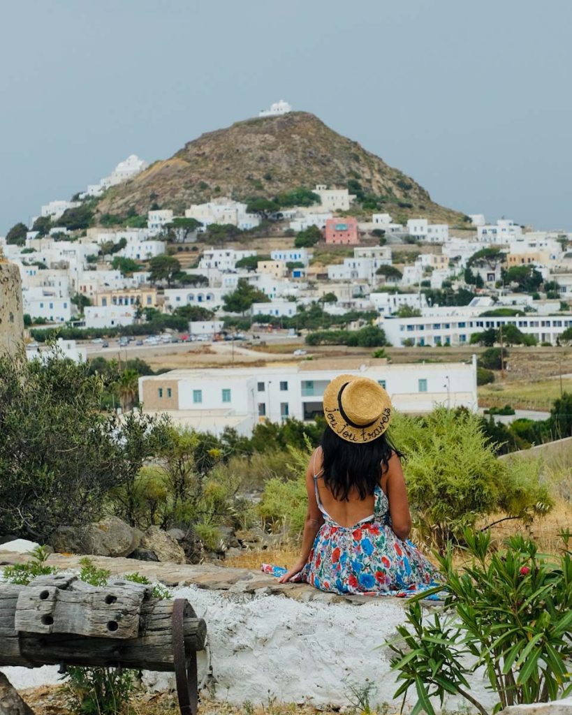 views of plaka from afar with female sitting in front with a hat