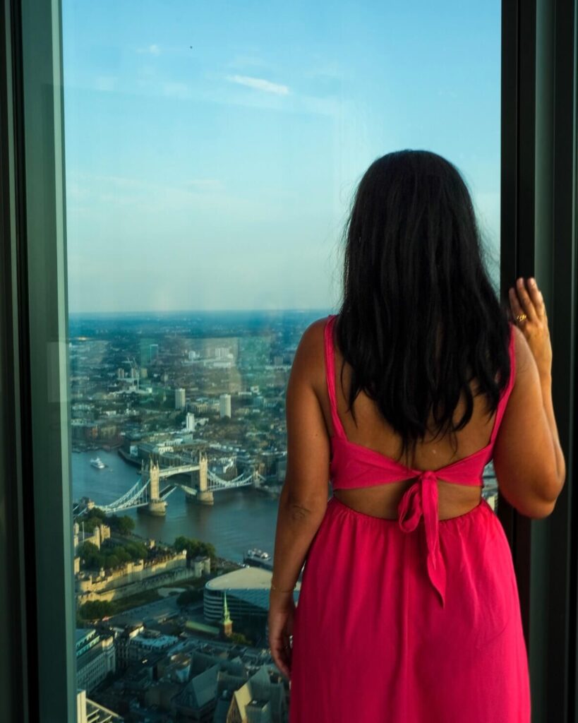 female looking out a window with a view of london at Horizon 22 Viewing Platform