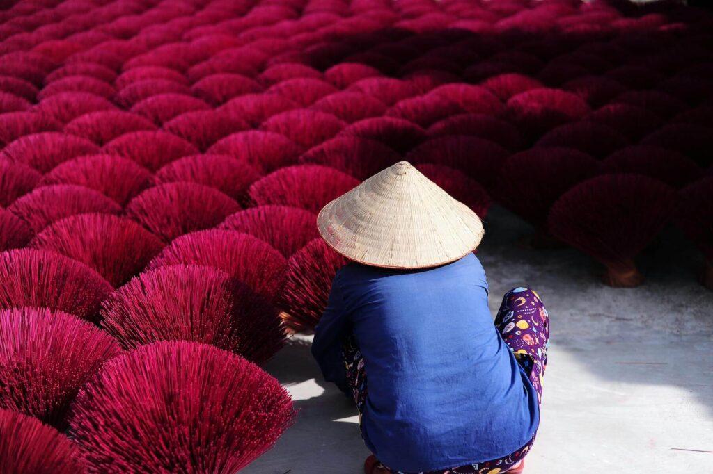 woman with inscense at Quảng Phú Cầu in Vietnam