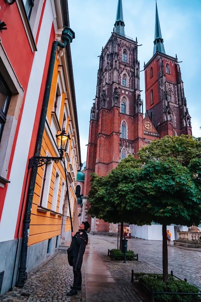 lamplighter light gas lamps at dusk in Wroclaw Poland