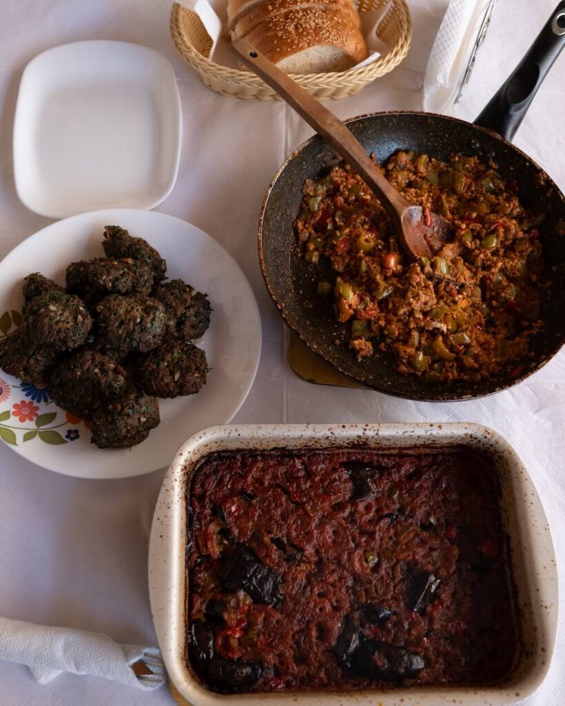 traditional food in albania including qofte, Patëllxhanë të Mbushur, and Speca të Mbushur me Djathë