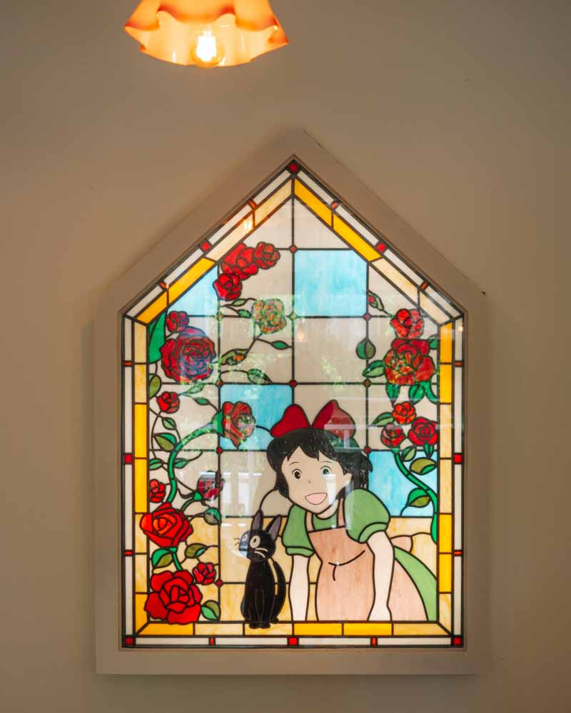 Stained glass featuring girl and cat