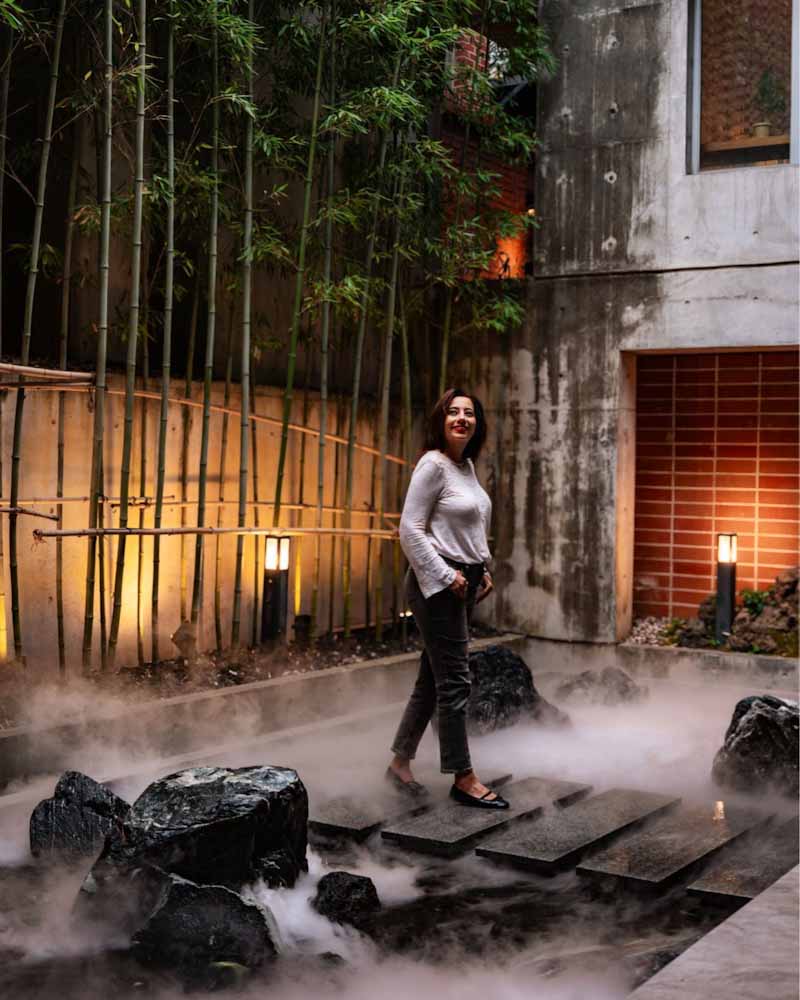 Woman walking through a misty garden at cafe saeraul in seoul